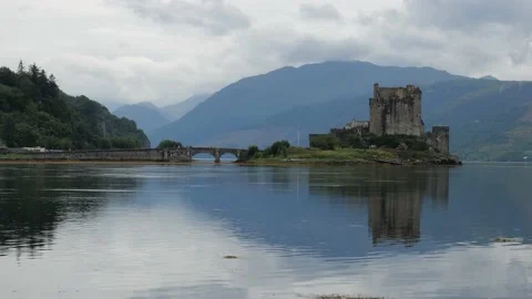 Reflection of Eilean Donan Castle, Scotland, UK and the bridge Stock Footage 133780777