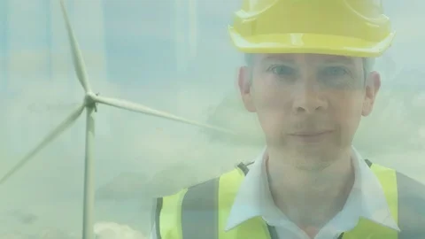 Reflection of an energy worker in front of a wind turbine Video stock 89372874