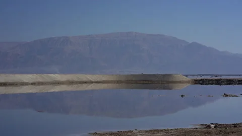 Reflection on an evaporation pond, Dead Sea Israel/Palestine Stock Footage 230106144