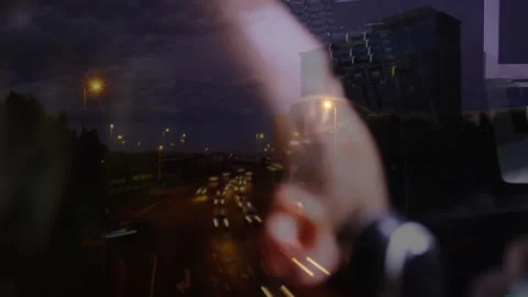 Reflection fading as camera shifting to man tuning headphones for audio testing Stock Footage 312695375