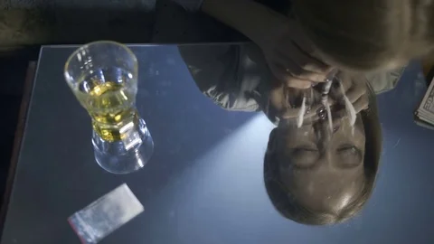 Reflection of female snorting coke line on mirror Stock Footage 84040225