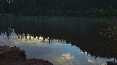 Reflection of forest and mist at sunrise on Mirror Lake Stock Footage 81853994