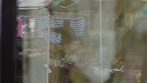 Reflection of fruit stall in shop window in rain Stock Footage 90171292