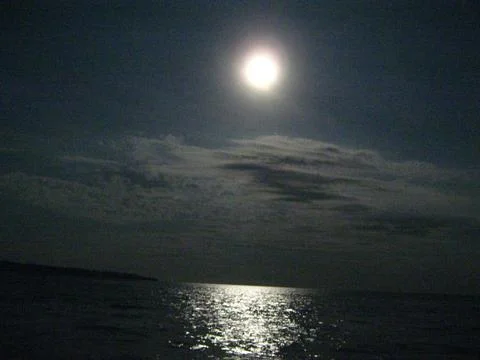 Reflection of Full moon in the sea Stock Photos