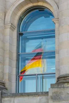 Reflection of german flag in reichstag window Stock Photos