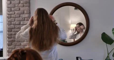 Reflection of girl dressing in round mirror. Stock Footage 327844468