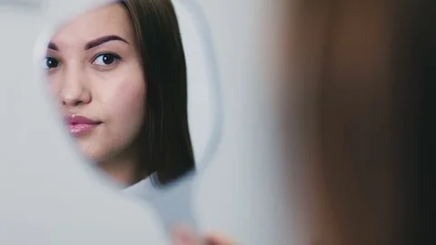 Reflection of a girl in the mirror close-up Stock Footage 76759942
