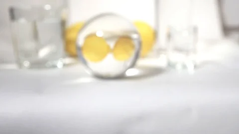 Reflection in a glass ball two yellow fresh lemon on white background Stock Footage 85674535