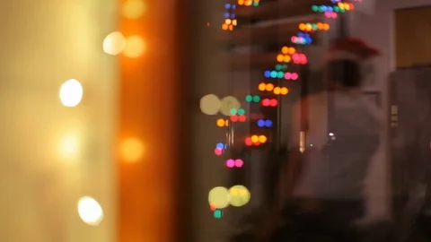 In the reflection of the glass Santa Claus is going to work. Video stock 70739149