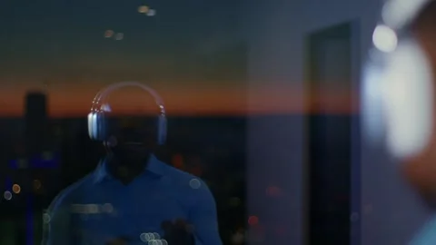 In the reflection of glass of a skyscraper dark-skinned man is dancing in Видео 267534262