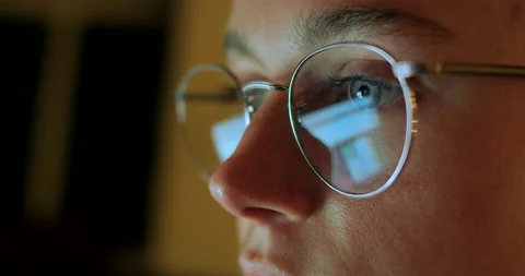 Reflection in glasses of woman working on computer Stock Footage 150148918