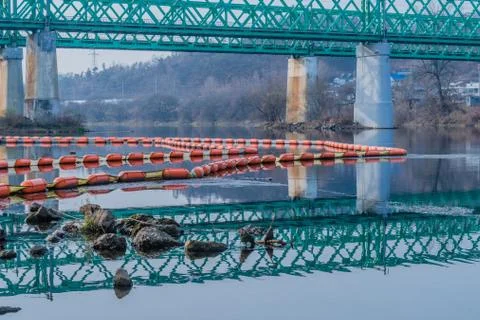 Reflection of green bridge in river Stock Photos