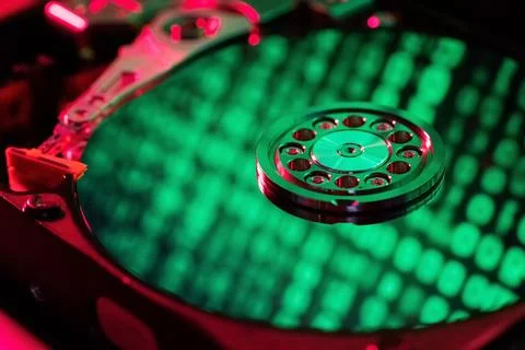 Reflection of green numbers in an open hard drive Stock Photos