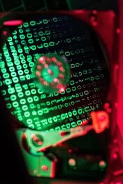 Reflection of green numbers in an open hard drive Stock Photos