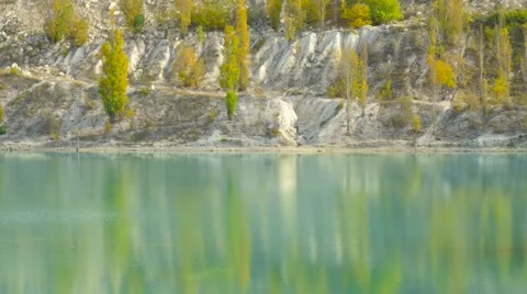 Reflection of green poplars on lake surface Stock Footage 68717353