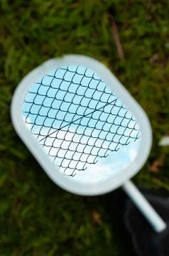 The reflection of the grid in the mirror on a blurred background. Fotos Stock