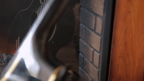 The reflection of the guitar in the fireplace 3 Stock Footage 71955811