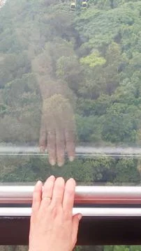 Reflection of hand with ring in window Stock Photos