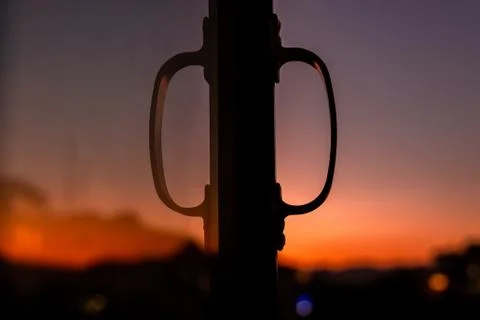 Reflection of the handle of a window during sunset and golden hour in the mou Stock Photos