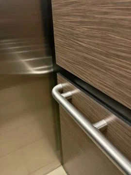 A reflection of a handrail in an elevator cab Stock Photos