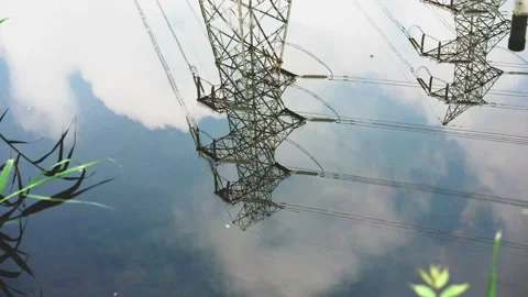 Reflection of high voltage electrical tower in water Video stock 197925408