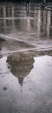 Reflection of Historic Architecture in Rainy Puddle Stock Photos