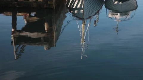 Reflection of Husavik Harbour in Iceland Stock Footage 135872625