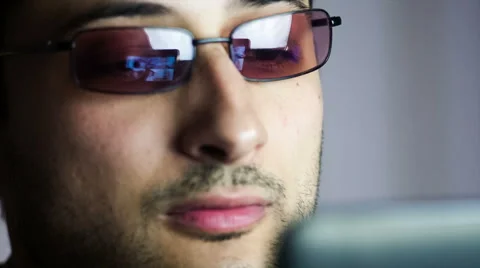 Reflection of information on the glasses of man who is working on computer Stock Footage 45642266