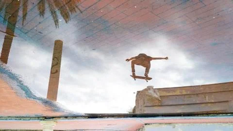 Reflection of a jumping skater Stock Photos
