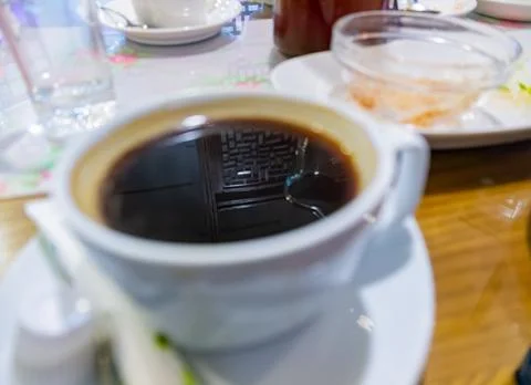 Reflection Of Keyboard In Coffee Cup Foto stock