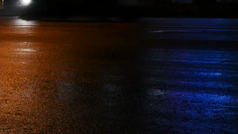 Reflection of light and color on the asphalt. Red and blue Stock Footage 85741842