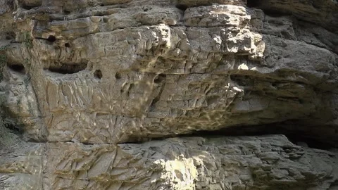 Reflection light cliff holes rock stone day sunlight valley Foradada water Stock Footage 329768761