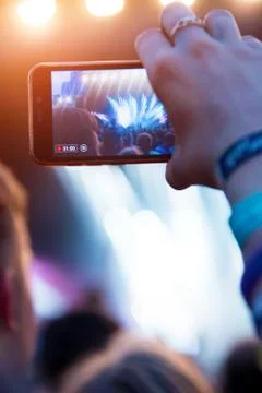 Reflection of light effects on  mobile phone at a concert (Gadgets, new devic Stock Photos