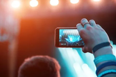Reflection of light effects on  mobile phone at a concert (Gadgets, new devic Stock Photos