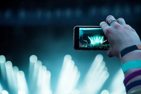 Reflection of light effects on  mobile phone at a concert (Gadgets, new devic Stock Photos