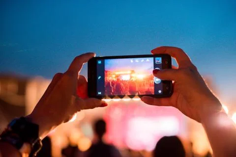 Reflection of light effects on  mobile phone at a concert (Gadgets, new devic Stock Photos