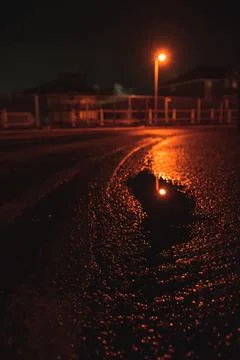 Reflection of the lighthouse in the puddle in the dark afternoon hours, Engla Stock Photos
