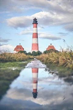 Reflection of Lighthouse Westerheversand Stock Photos