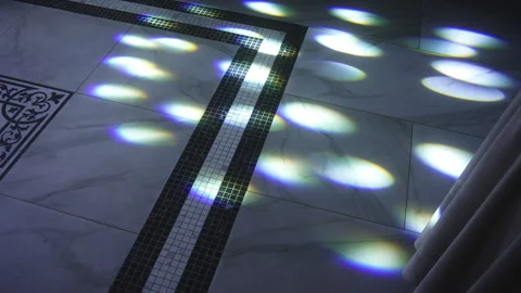 A reflection of lights on a wall in a dark room Vidéo 265572325