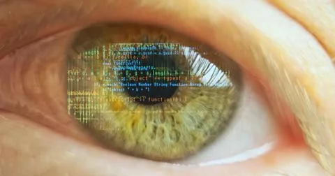 Reflection of lines of computer code in the human eye, close-up, macro. Concept Stock Photos