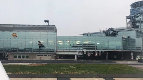 Reflection of the Lufthansa aircraft in the windows of the terminal building Stock Footage 107138707