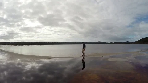 Reflection of male walking next to perched lake on Fraser Island Video stock 71479983