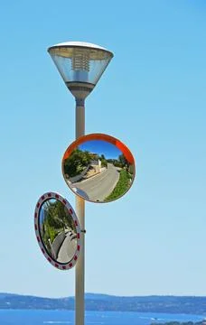 Reflection of a man with a camera in the mirror Stock Photos