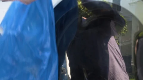 Reflection of man with gloves loading laundry  Stock Footage 117432948