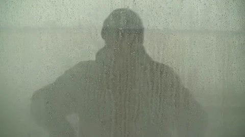 Reflection Of Man "Hands On Head" In Water Droplet Covered Window Stock Footage 19057621