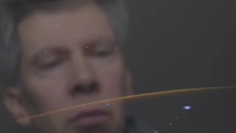 Reflection of a man looking at a view of the earth from space Video stock 102592966