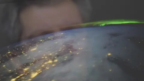 Reflection of a man looking at a view of the earth from space Video stock 102598370