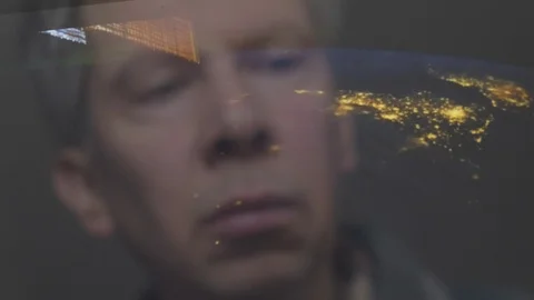 Reflection of a man looking at a view of the earth from space Video stock 102606645