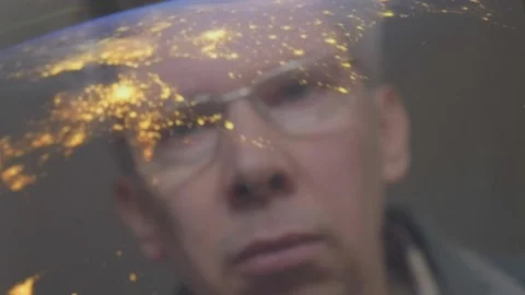 Reflection of a man looking at a view of the earth from space Video stock 102615897