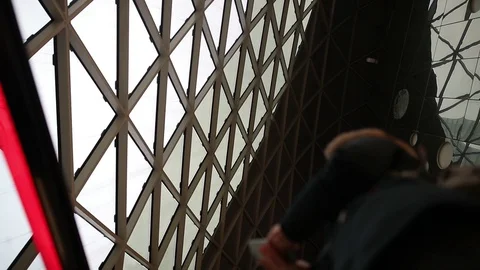 Reflection of a man in the mirrored windows of a skyscraper Stock Footage 128547811